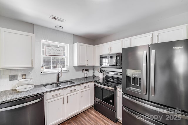 5116 Crane Point Dr, Charlotte, NC 28227 - kitchen featuring stainless steel appliances, dark stone counters, and white cabinets