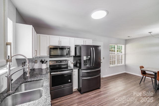 5116 Crane Point Dr, Charlotte, NC 28227 - kitchen featuring stainless steel appliances, white cabinets, wood finished floors, and stone counters