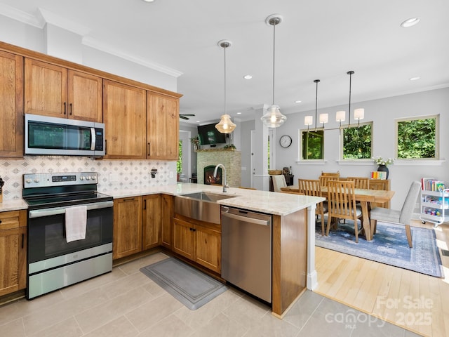 102 Gap Creek Rd, Fletcher, NC 28732 - kitchen featuring appliances with stainless steel finishes, decorative backsplash, brown cabinetry, crown molding, and recessed lighting