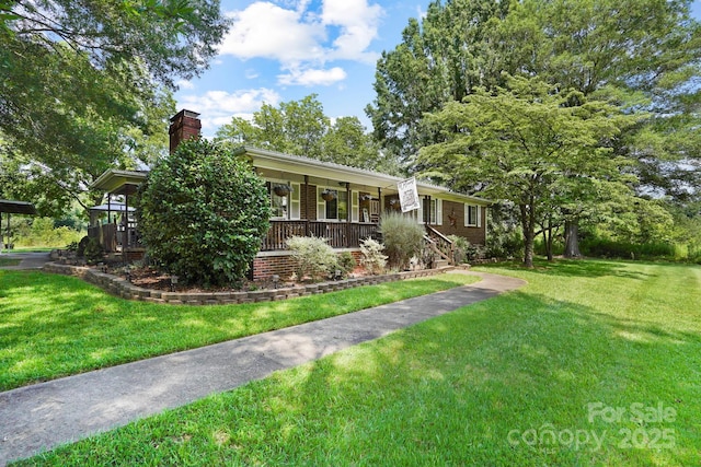 1104 Pump Station Rd, Kannapolis, NC 28081 - ranch-style house featuring a chimney, covered porch, and a front lawn