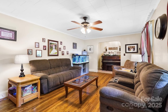 1104 Pump Station Rd, Kannapolis, NC 28081 - living room featuring wood finished floors, ceiling fan, arched walkways, and ornamental molding