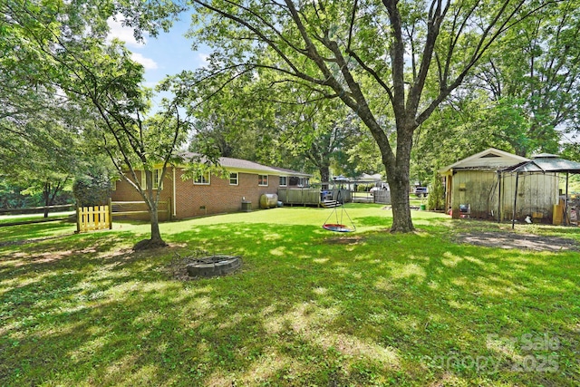 1104 Pump Station Rd, Kannapolis, NC 28081 - view of yard featuring a fire pit