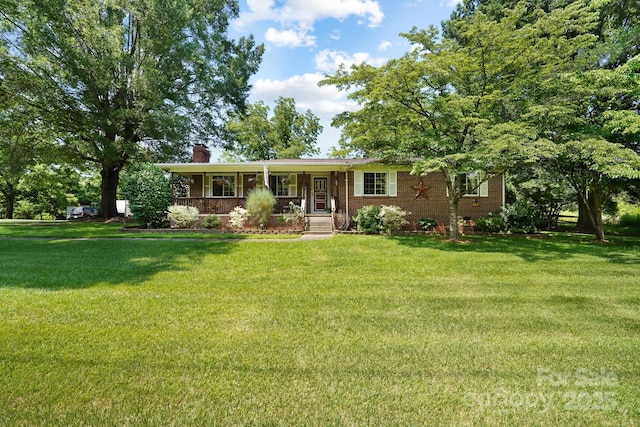 1104 Pump Station Rd, Kannapolis, NC 28081 - ranch-style home with covered porch, a chimney, a front yard, and brick siding