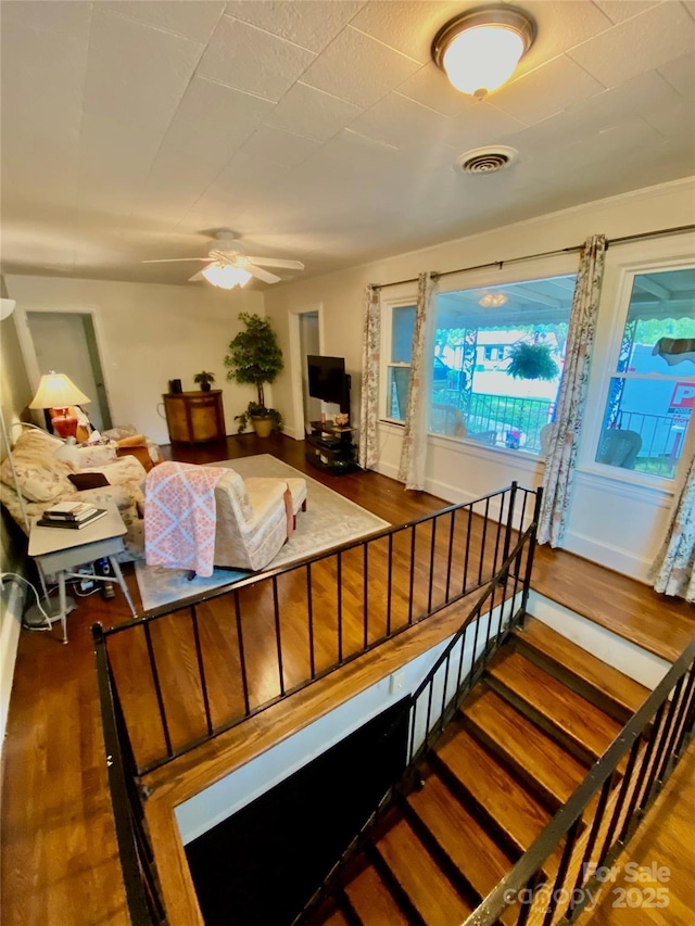 3702 Crawford St, Gastonia, NC 28052 - living room featuring wood finished floors, ceiling fan, and stairs