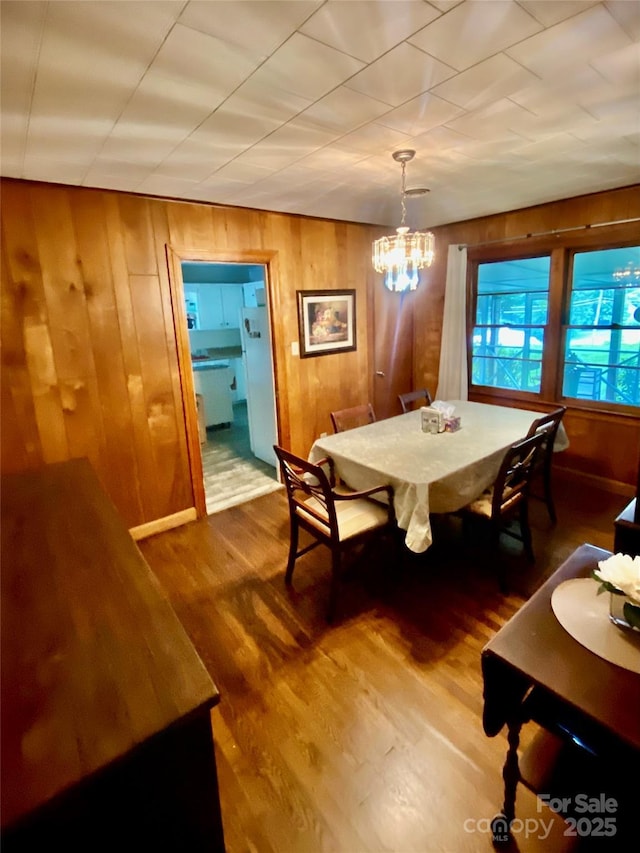3702 Crawford St, Gastonia, NC 28052 - dining area with a chandelier, wood finished floors, and wood walls