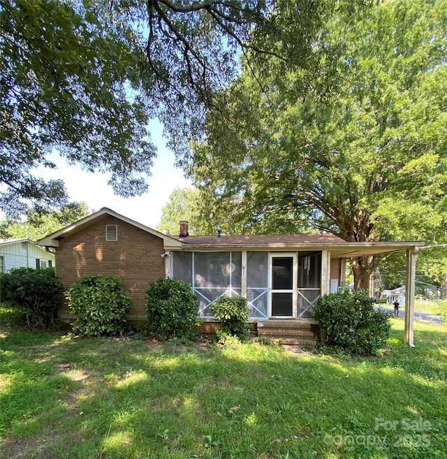 3702 Crawford St, Gastonia, NC 28052 - ranch-style home with a sunroom, a front yard, brick siding, and a chimney