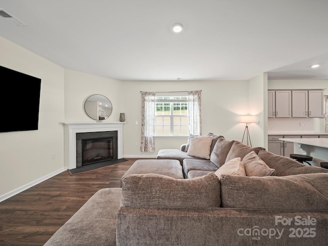 404 Saddlebred Ln, Locust, NC 28097 - living room featuring dark wood-type flooring, a fireplace with flush hearth, and recessed lighting