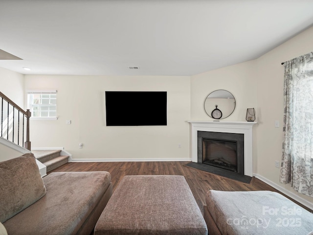 404 Saddlebred Ln, Locust, NC 28097 - living area with wood finished floors, stairs, and a fireplace with flush hearth