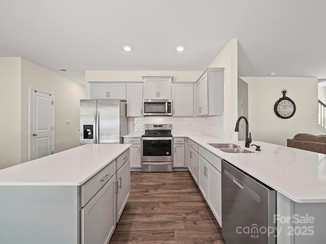 404 Saddlebred Ln, Locust, NC 28097 - kitchen featuring stainless steel appliances, dark wood finished floors, light countertops, backsplash, and a peninsula