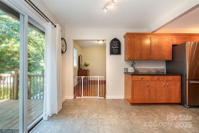 4919 Rehobeth Rd, Waxhaw, NC 28173 - kitchen with freestanding refrigerator, dark countertops, and brown cabinets