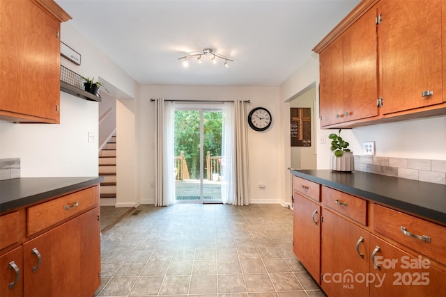4919 Rehobeth Rd, Waxhaw, NC 28173 - kitchen with dark countertops, brown cabinets, and light tile patterned floors