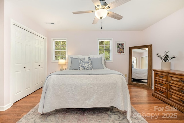 4919 Rehobeth Rd, Waxhaw, NC 28173 - bedroom featuring wood finished floors, multiple windows, a closet, and a ceiling fan