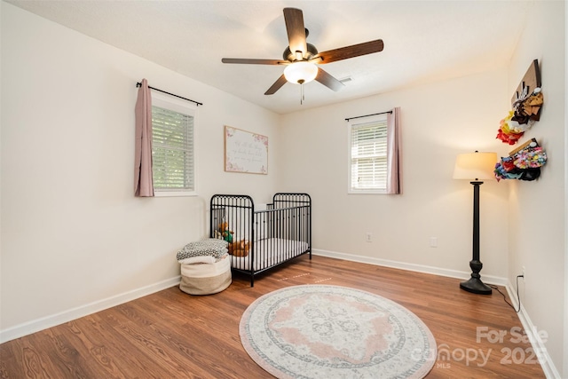 4919 Rehobeth Rd, Waxhaw, NC 28173 - bedroom featuring wood finished floors, a crib, and ceiling fan