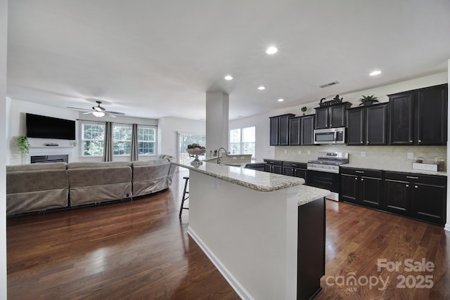 248 Catoctin Rd, Rock Hill, SC 29732 - kitchen with stainless steel appliances, open floor plan, a kitchen bar, dark cabinets, and dark wood-style flooring