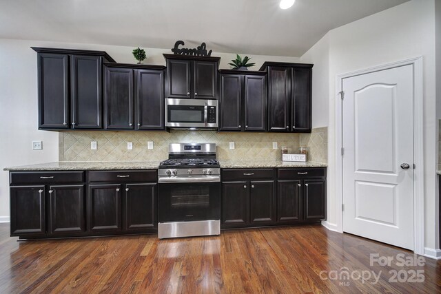 248 Catoctin Rd, Rock Hill, SC 29732 - kitchen with appliances with stainless steel finishes, backsplash, dark cabinets, dark wood-style floors, and light stone countertops