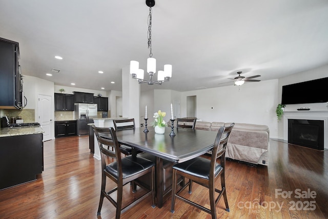 248 Catoctin Rd, Rock Hill, SC 29732 - dining space with a chandelier, a ceiling fan, dark wood-style flooring, a fireplace, and recessed lighting