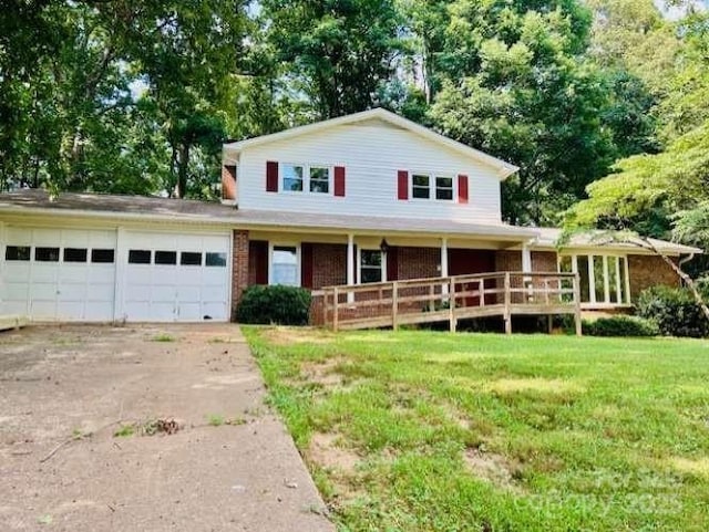 2660 Tiffany St, Conover, NC 28613 - view of front facade featuring an attached garage, driveway, a front yard, a porch, and brick siding
