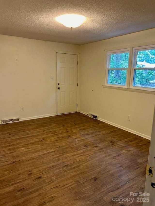 2660 Tiffany St, Conover, NC 28613 - unfurnished room with a textured ceiling and dark wood finished floors