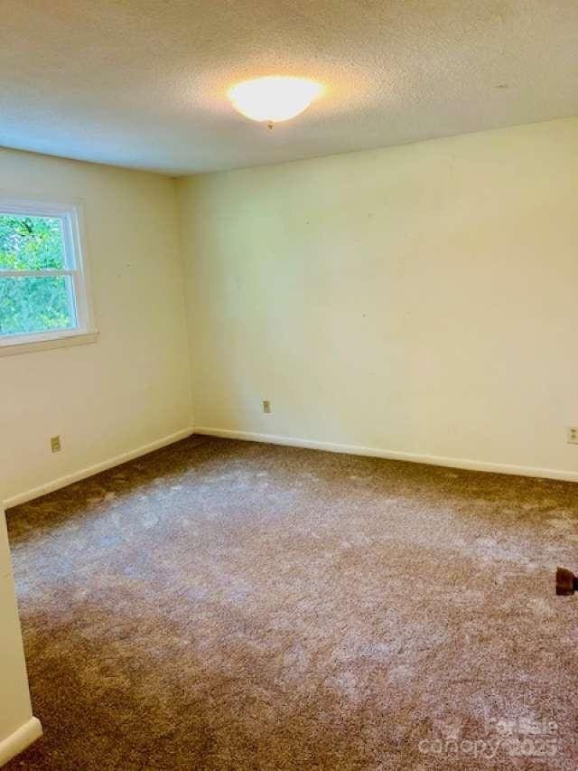 2660 Tiffany St, Conover, NC 28613 - spare room with carpet flooring and a textured ceiling