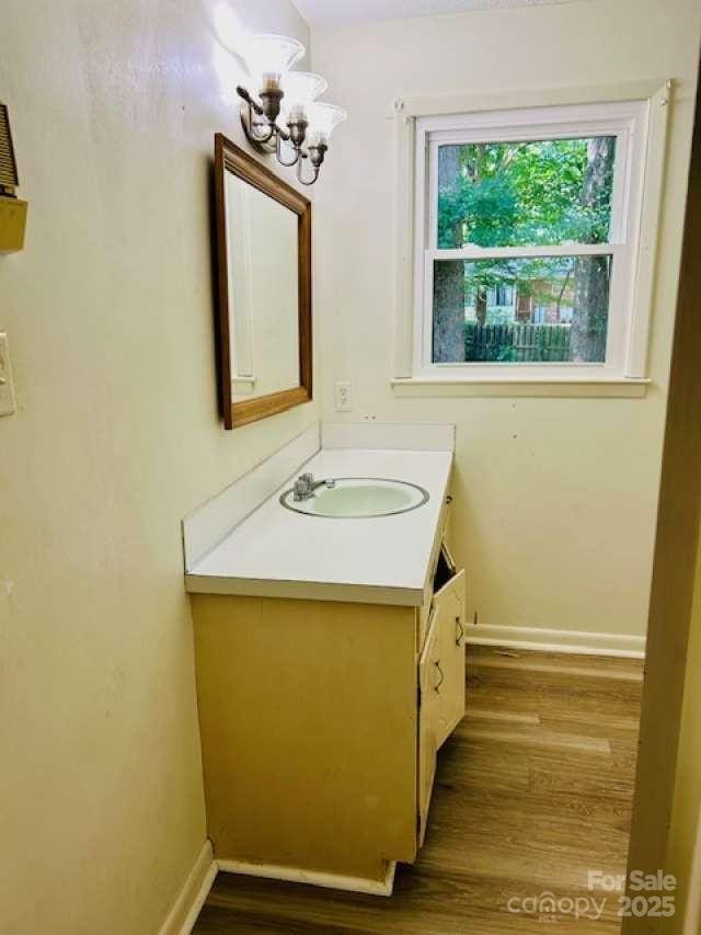 2660 Tiffany St, Conover, NC 28613 - bathroom featuring vanity, a chandelier, and wood finished floors