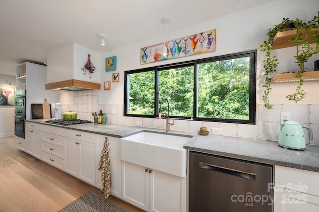 136 Graveyard Rd, Fairview, NC 28730 - kitchen featuring appliances with stainless steel finishes, open shelves, light wood-style floors, backsplash, and white cabinets