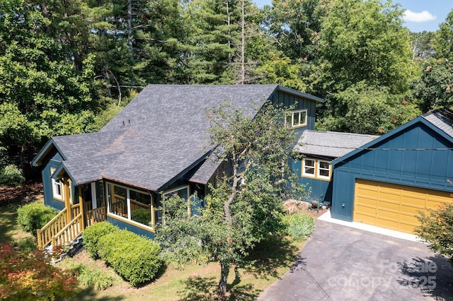 136 Graveyard Rd, Fairview, NC 28730 - rustic home featuring board and batten siding, a shingled roof, asphalt driveway, and an attached garage