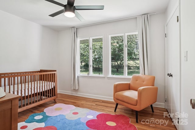 7107 Cedarfield Rd, Charlotte, NC 28227 - bedroom featuring a crib and wood finished floors