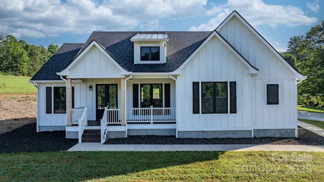 3981 Zero Mull Rd, Morganton, NC 28655 - modern farmhouse with roof with shingles, covered porch, board and batten siding, and a front yard