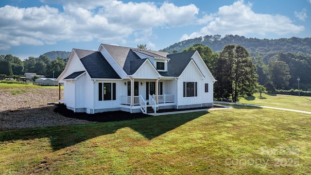 3981 Zero Mull Rd, Morganton, NC 28655 - modern farmhouse with a porch, board and batten siding, a front yard, a mountain view, and a shingled roof