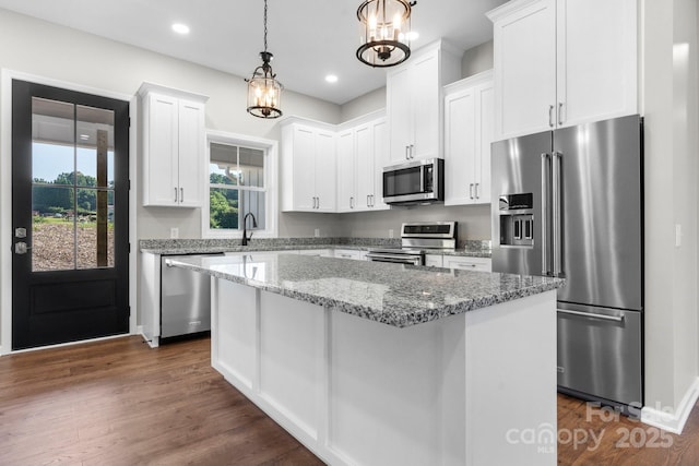 3981 Zero Mull Rd, Morganton, NC 28655 - kitchen featuring stainless steel appliances, white cabinets, a kitchen island, dark wood finished floors, and pendant lighting