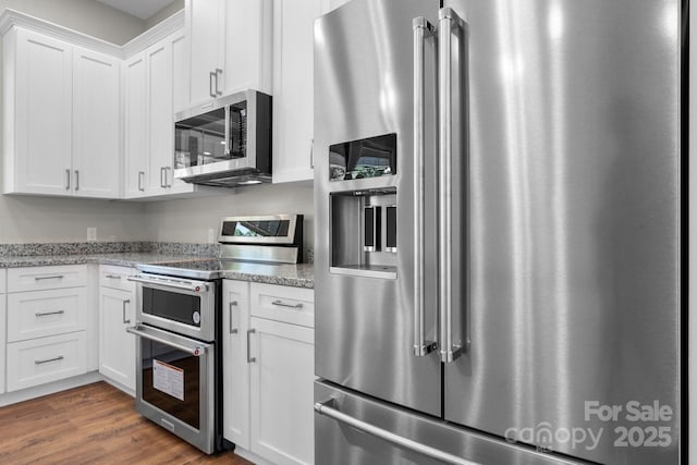 3981 Zero Mull Rd, Morganton, NC 28655 - kitchen featuring stainless steel appliances, white cabinetry, dark wood finished floors, and light stone counters