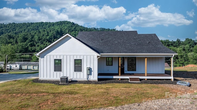 3981 Zero Mull Rd, Morganton, NC 28655 - modern inspired farmhouse featuring a porch, a view of trees, a front lawn, and board and batten siding