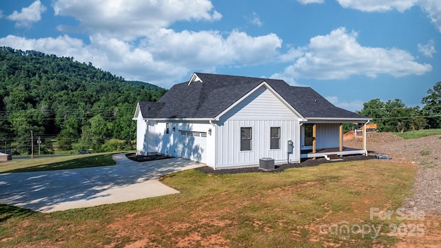 3981 Zero Mull Rd, Morganton, NC 28655 - view of front of property featuring board and batten siding, covered porch, a garage, a front yard, and driveway