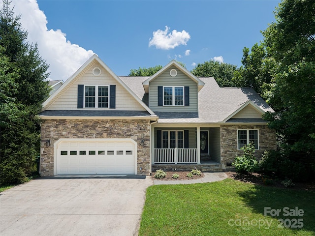19 Driftstone Cir, Arden, NC 28704 - craftsman-style home featuring stone siding, concrete driveway, a porch, a front lawn, and a garage