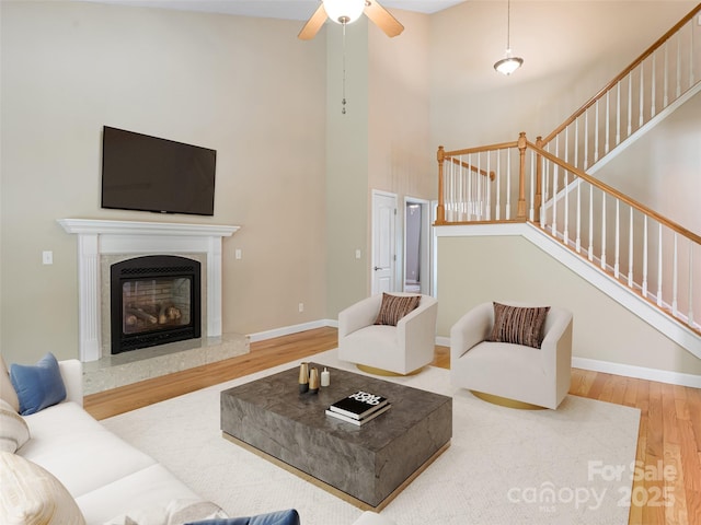19 Driftstone Cir, Arden, NC 28704 - living area featuring wood finished floors, a high ceiling, stairway, a ceiling fan, and a high end fireplace