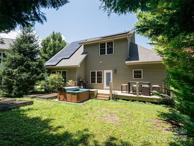 19 Driftstone Cir, Arden, NC 28704 - rear view of house with a hot tub, a lawn, roof mounted solar panels, and roof with shingles