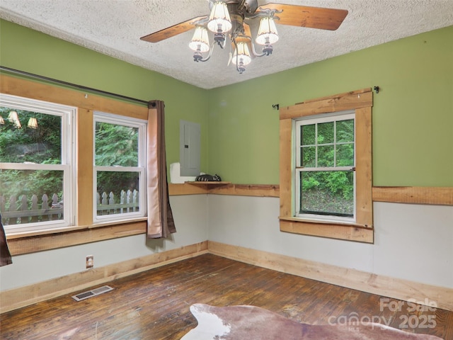 32 Saunooke Rd, Asheville, NC 28805 - unfurnished room with a textured ceiling, hardwood / wood-style floors, ceiling fan, plenty of natural light, and electric panel