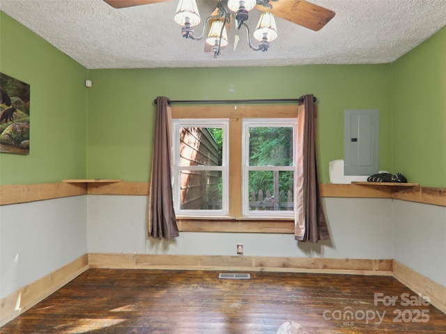 32 Saunooke Rd, Asheville, NC 28805 - unfurnished room with electric panel, a textured ceiling, hardwood / wood-style flooring, and a chandelier