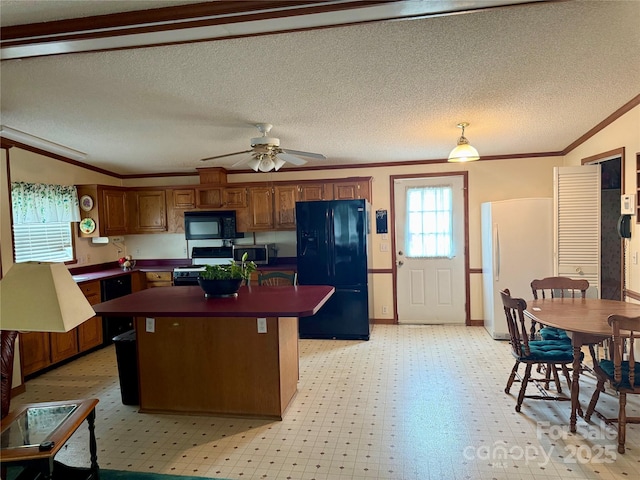 5816 Scotland Yard Rd, Rock Hill, SC 29732 - kitchen with black appliances, dark countertops, ornamental molding, a center island, and brown cabinets