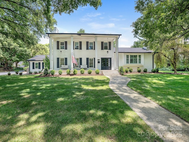 3001 Colony Rd, Charlotte, NC 28211 - greek revival house featuring french doors, a front lawn, and stucco siding