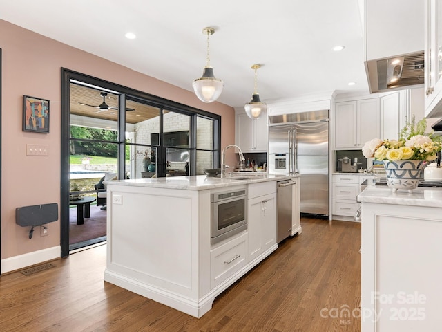 3001 Colony Rd, Charlotte, NC 28211 - kitchen with stainless steel appliances, a kitchen island with sink, white cabinetry, dark wood-style floors, and recessed lighting