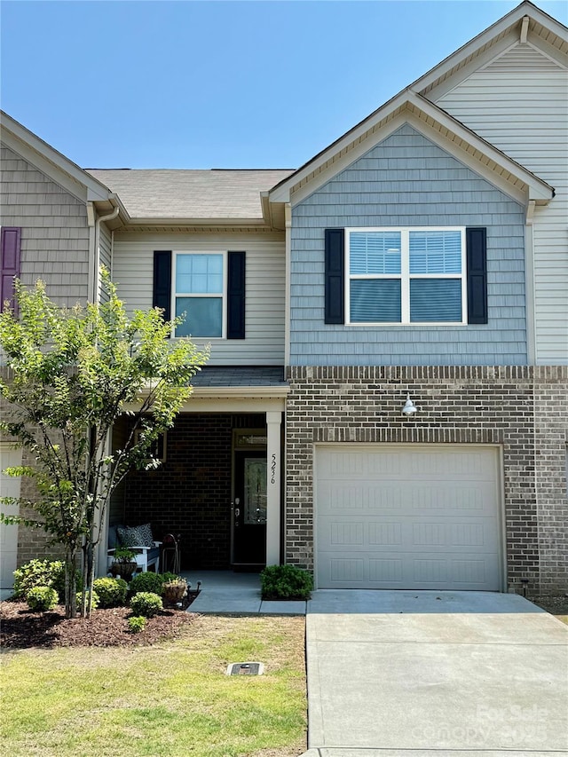 5236 Spanish Ivy Ln, Indian Land, SC 29707 - view of front of house with concrete driveway, a garage, brick siding, and a front yard