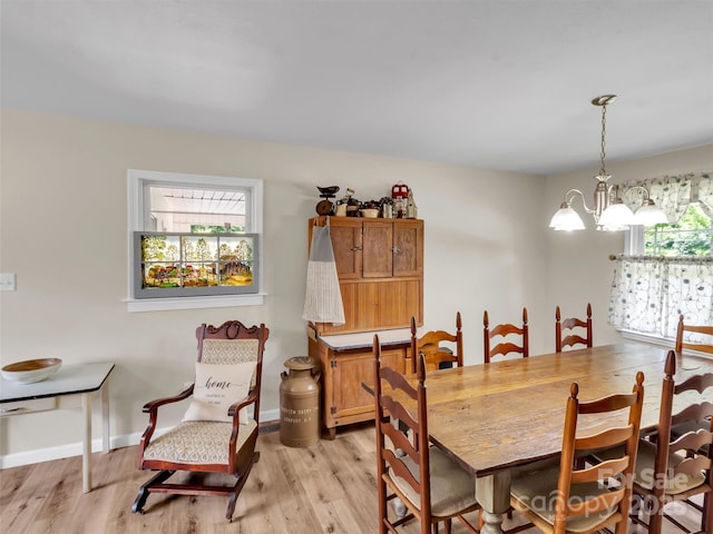 463 Golf Course Rd, Clyde, NC 28721 - dining space featuring healthy amount of natural light, light wood-style flooring, and a chandelier