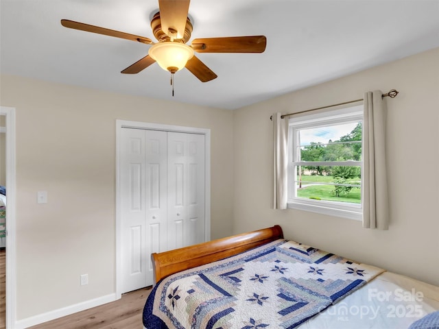463 Golf Course Rd, Clyde, NC 28721 - bedroom with light wood-style flooring, a closet, and a ceiling fan