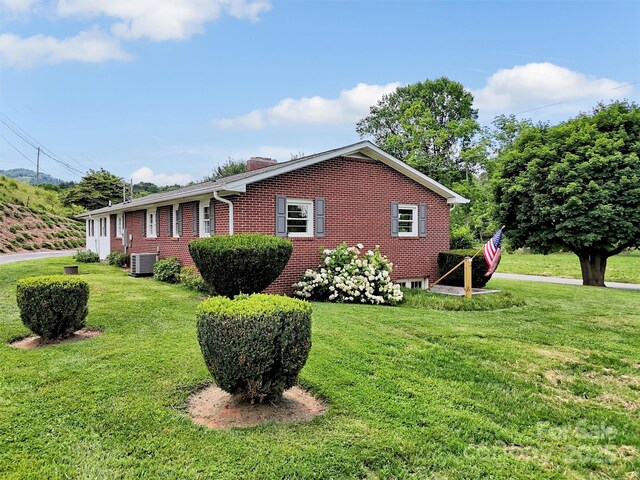463 Golf Course Rd, Clyde, NC 28721 - view of property exterior with brick siding, a yard, and a chimney