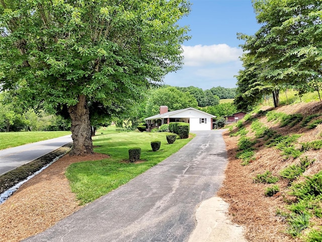 463 Golf Course Rd, Clyde, NC 28721 - view of front of property with a front yard, a chimney, and asphalt driveway