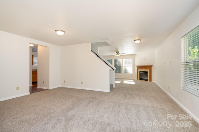 1432 Matthew Allen Cir, Kannapolis, NC 28081 - unfurnished living room with carpet flooring, a ceiling fan, a fireplace with flush hearth, and stairs