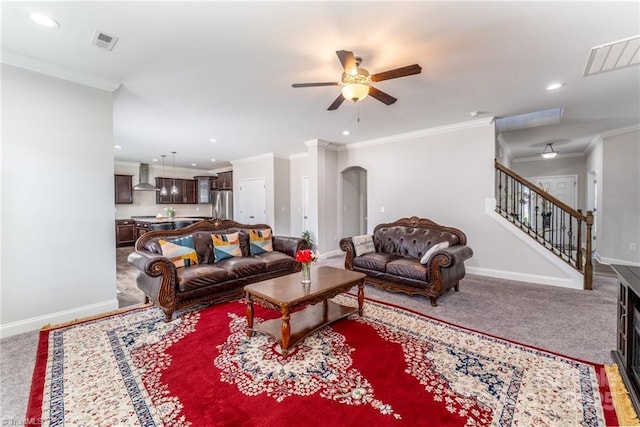 2110 Owls View Ln, Colfax, NC 27235 - carpeted living area with crown molding, ceiling fan, recessed lighting, stairway, and arched walkways
