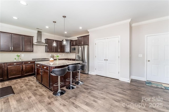 2110 Owls View Ln, Colfax, NC 27235 - kitchen featuring wall chimney exhaust hood, appliances with stainless steel finishes, dark brown cabinets, light wood finished floors, and ornamental molding