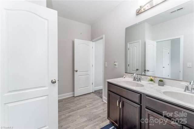 2110 Owls View Ln, Colfax, NC 27235 - bathroom featuring double vanity and wood finished floors